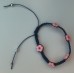 ARMBAND geknoopt BLAUW met 5 ROZE bloemetjes